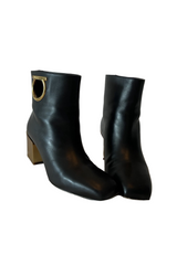 Black leather boots with golden heel