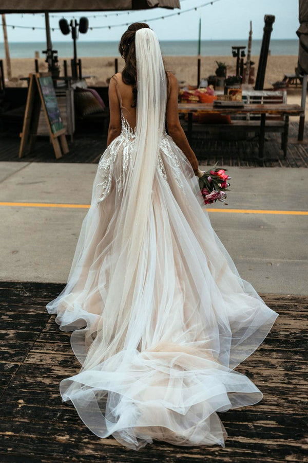 Fitted wedding dress covered in pearls and embroidery